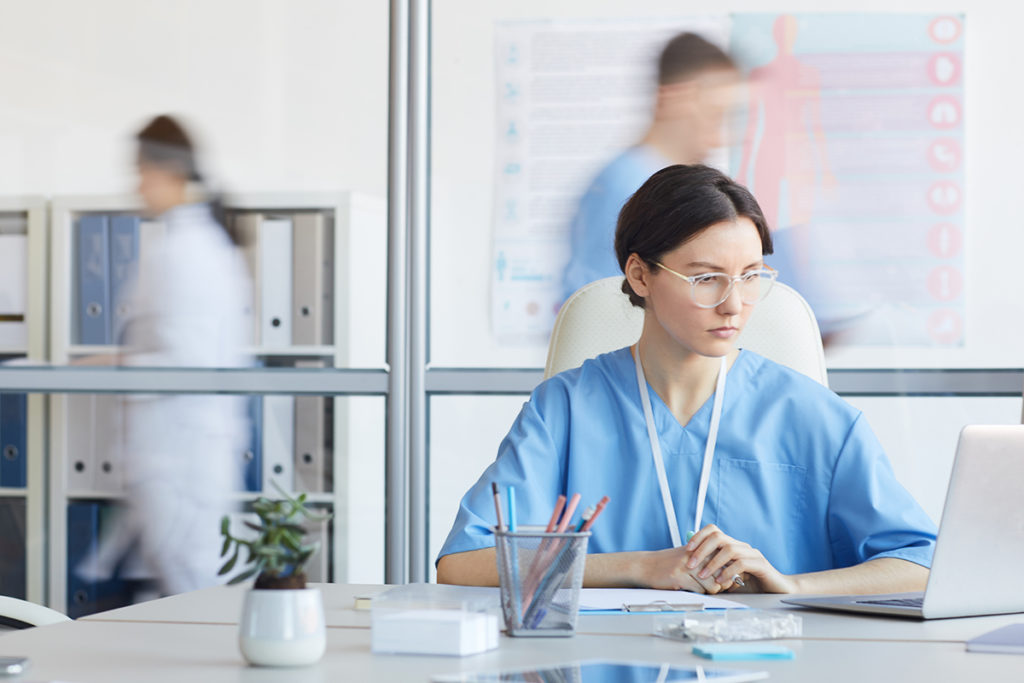 young female nurse using computer