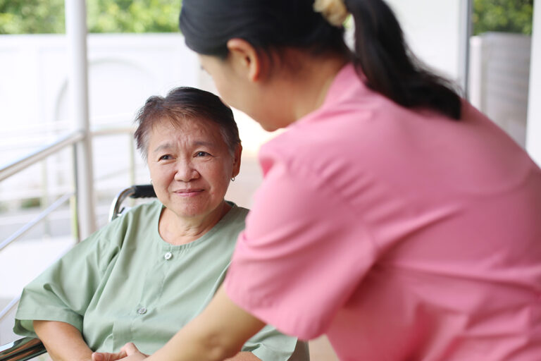 Nurse And Senior Patient In A Wheelchair