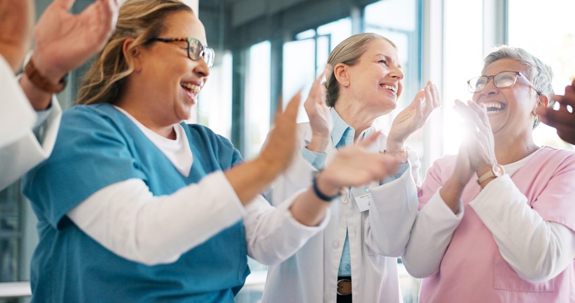 Doctor, support and applause in celebration for team unity, healthcare achievement or goal at the h.