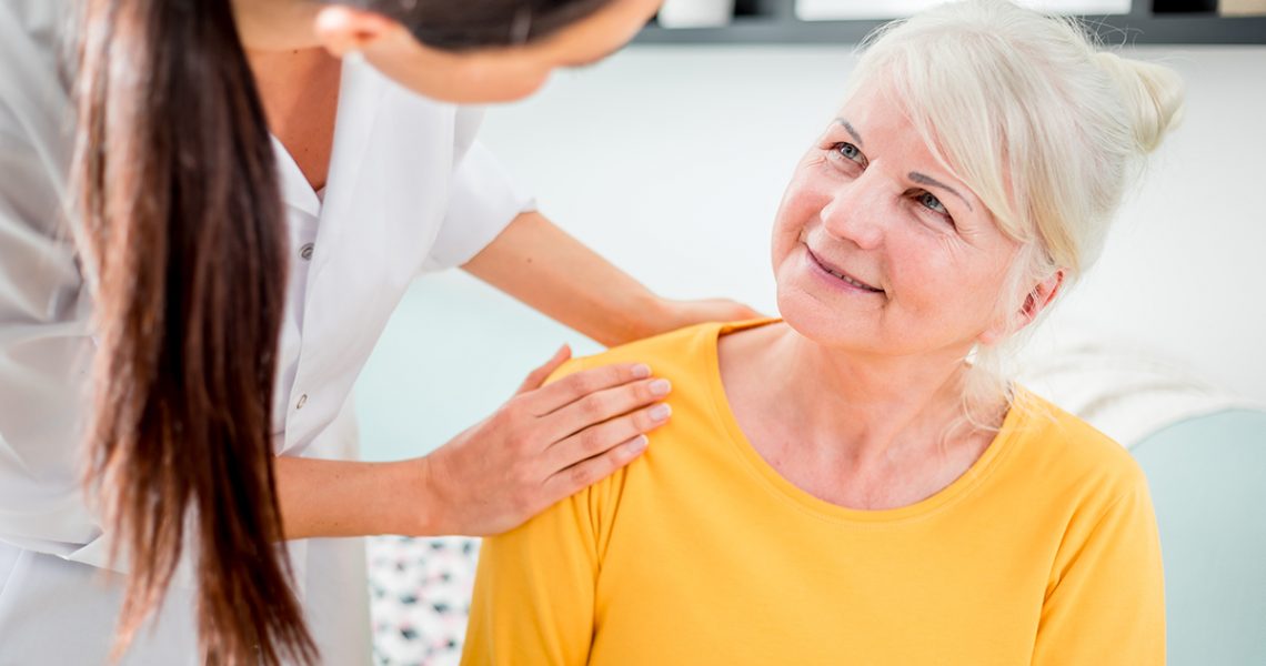 Nurse during home visit talking with senior female and giving treatment advices