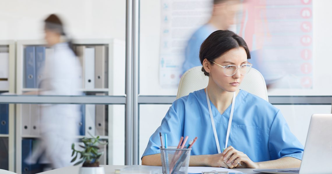 young female nurse using computer